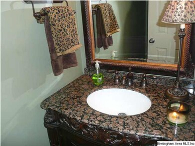 Main level half bath feautures a furniture-style v