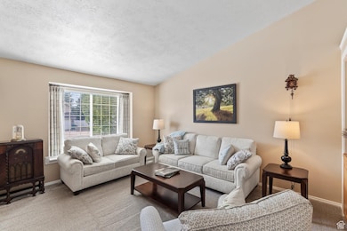 Living room with vaulted ceiling and window seat