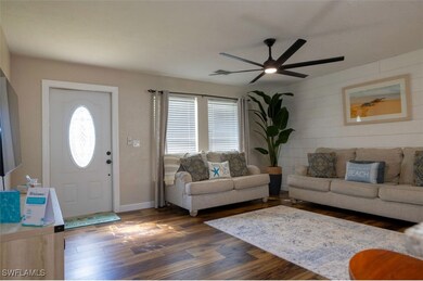 Living room with dark wood-type flooring and ceili
