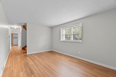 Spare room featuring light wood-style floors, stairway, and washer / clothes dryer
