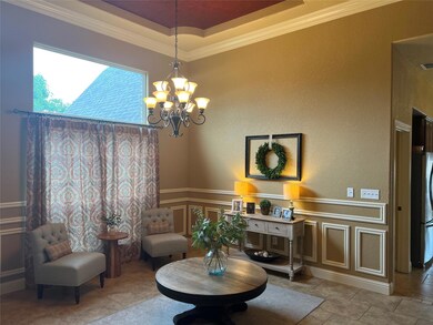 Tiled living room featuring ornamental molding, a 
