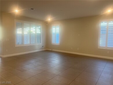 Spare room with tile patterned floors and baseboar