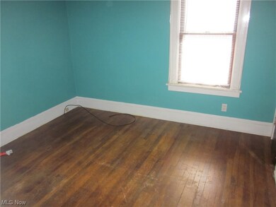 Unfurnished room with dark wood-type flooring