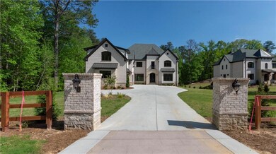 French country home with a front lawn, fence, and 