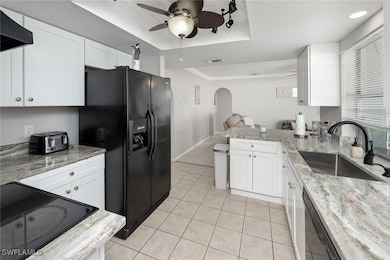 Kitchen with black appliances, sink, va raised cei