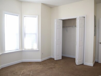 Unfurnished bedroom with carpet and a closet