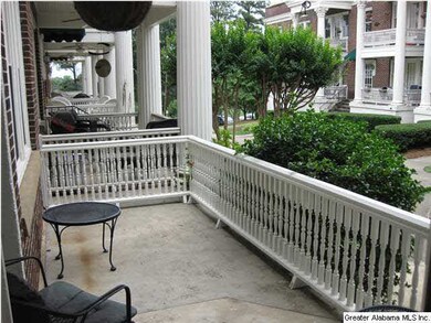 Spacious covered balcony overlooks manicured lawn