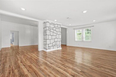 Empty room featuring light wood-type flooring, baseboards, and recessed lighting