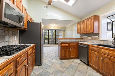 Kitchen has double ovens, 5 burner gas cooktop.