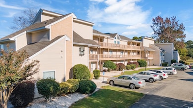 View of property featuring uncovered parking