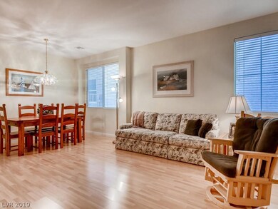 Separate living room and dining area with neutral