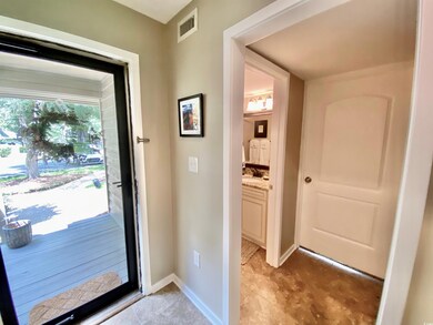Doorway featuring light tile patterned floors