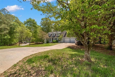 View of front of house with driveway, a garage, and a front yard