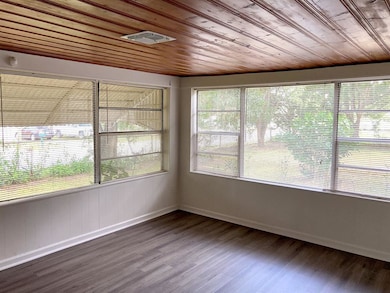 Enter into the living room with a ton of windows
