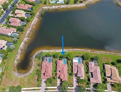 Aerial view of property and surrounding area featuring nearby suburban area and a large body of water