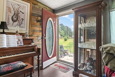 Foyer entrance featuring wood walls and wood finished floors