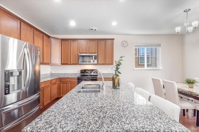 Open layout kitchen with an island, SS appliances and granite countertops