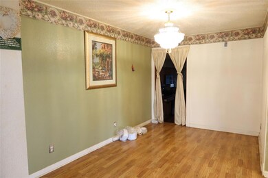 Unfurnished room with a chandelier, wood-type floo