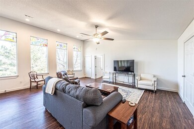 Living area on second floor with wall of windows,