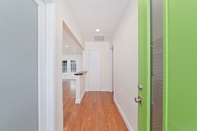 A fresh green front door adds a pop of color and c