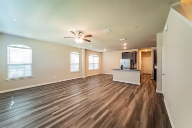 Livingliving/kitchen/dining area with luxury vinyl plan flooring. Staircase is on the right.