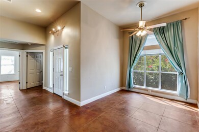 Unfurnished dining area featuring tile patterned floors and a ceiling fan