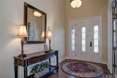 GRAND ENTRY HAS WOOD & GLASS DOOR, HARDWOOD FLOOR