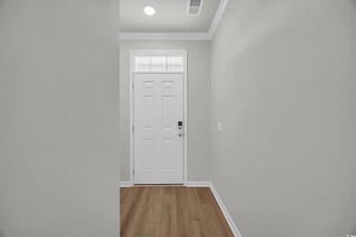 Entryway with light wood-type flooring, ornamental