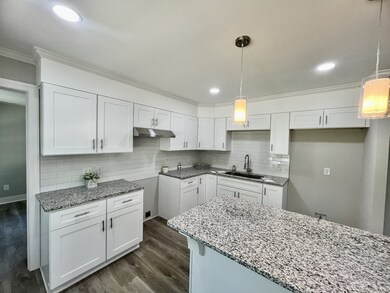 This is a closer view of the kitchen.  The Stove and Refrigerator will be installed. The counters are granite and the backsplash is a nice white tile.   The sink is a farm sink with a tall faucet which is great when cleaning deep big pans.