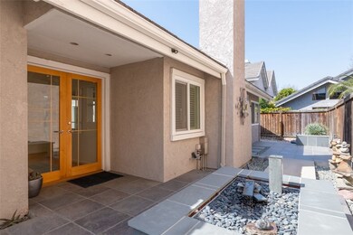 Double-door front entrance with rock and fountain garden.