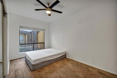 Bedroom featuring wood finished floors and basebo
