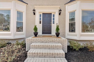 Entrance to property featuring brick siding