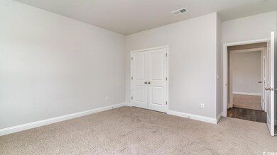 Unfurnished bedroom featuring light colored carpet