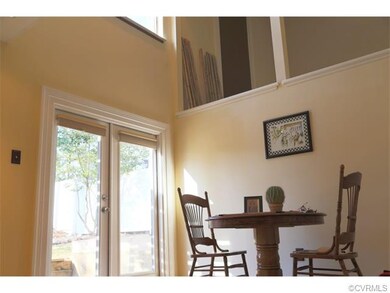 Dining area with views of the back yard and vaulte