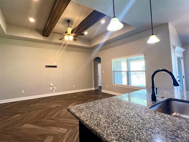 Kitchen featuring beamed ceiling, pendant lighting