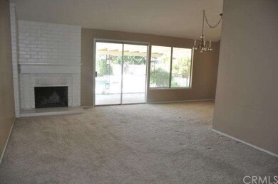 living room with brick fireplace