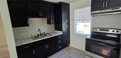 Kitchen featuring electric range, under cabinet ra