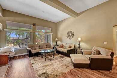 Living room with beam ceiling, wood finished floor