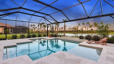 Pool featuring a water view, a patio area, an in ground hot tub, and glass enclosure