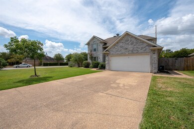 Not only can the driveway comfortably fit 4 cars,