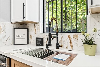 Kitchen view of backsplash, light countertops, and