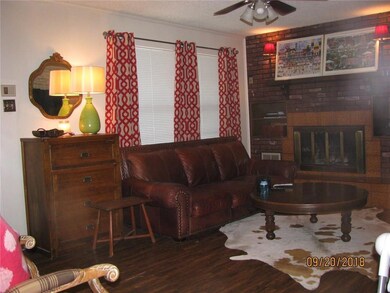 Living room with fireplace and laminate flooring