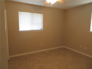 Bedroom one features a ceiling fan