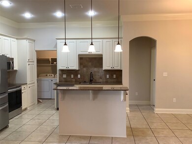 Kitchen featuring hanging light fixtures, light ti