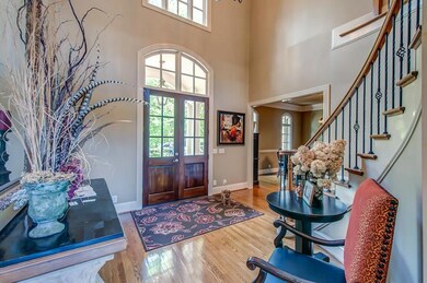 Foyer with double doors and spiral staircase.