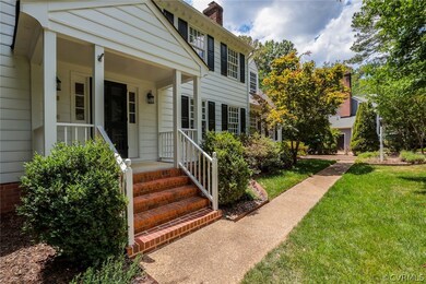 Entrance to property featuring a lawn and a porch