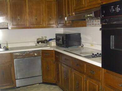 The kitchen has cooktop and built-in oven plus a d