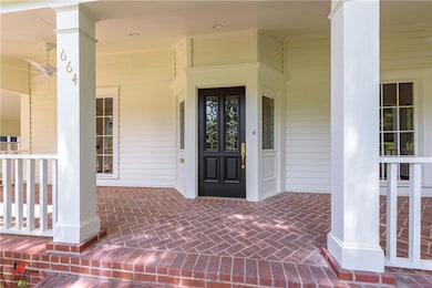 Welcoming brick front porch is a perfect place to 