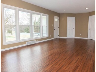Spacious formal living room with wood flooring.