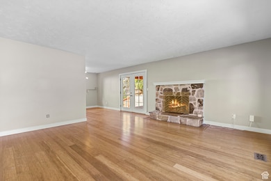 Spacious living room with cozy fireplace and hardwood floors
